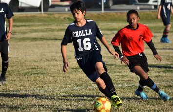  student in cholla soccer jersey running